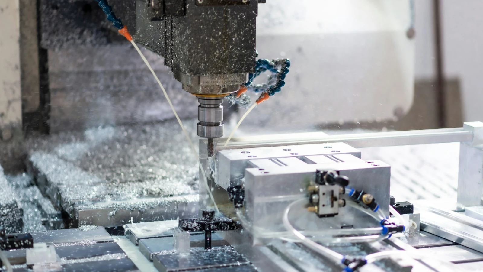 A CNC milling machine cutting a metal part